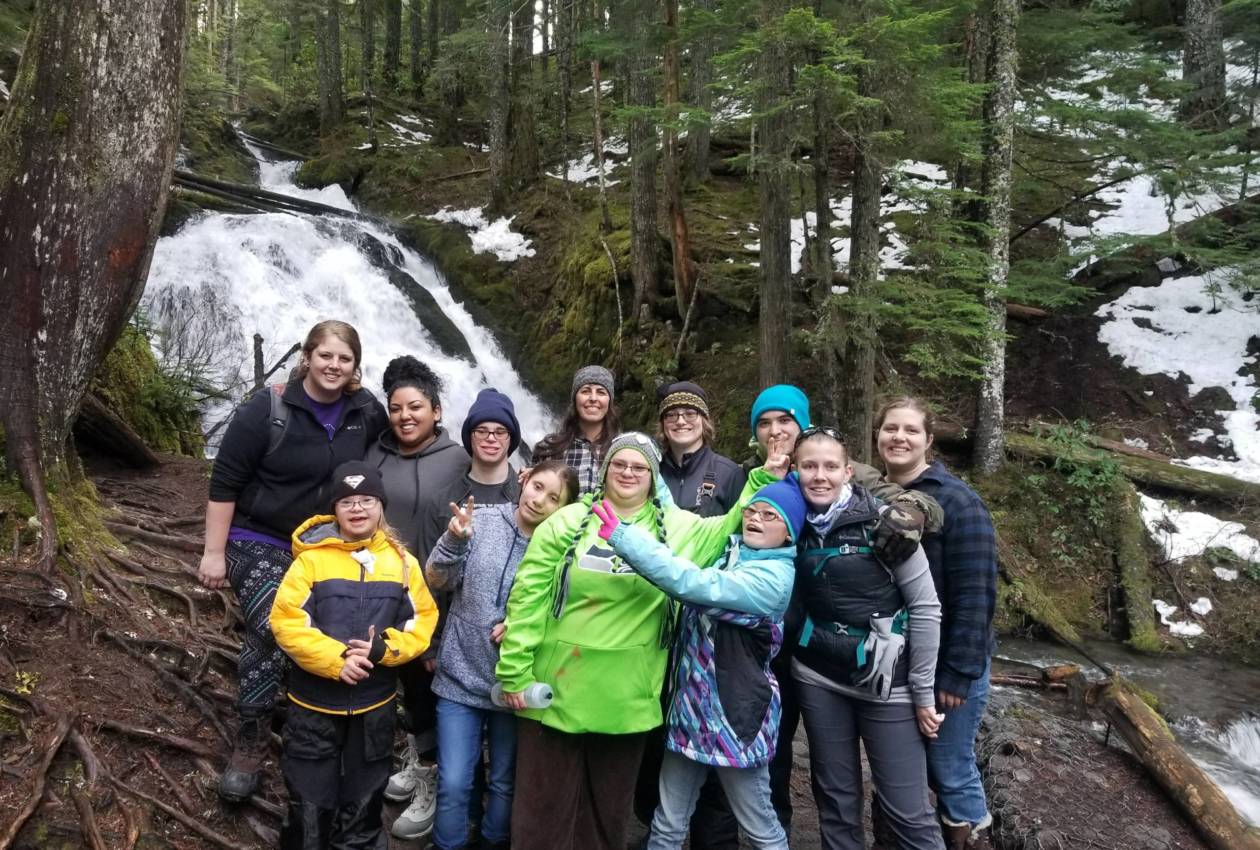 Winter Retreat campers and staff in front of a waterfall